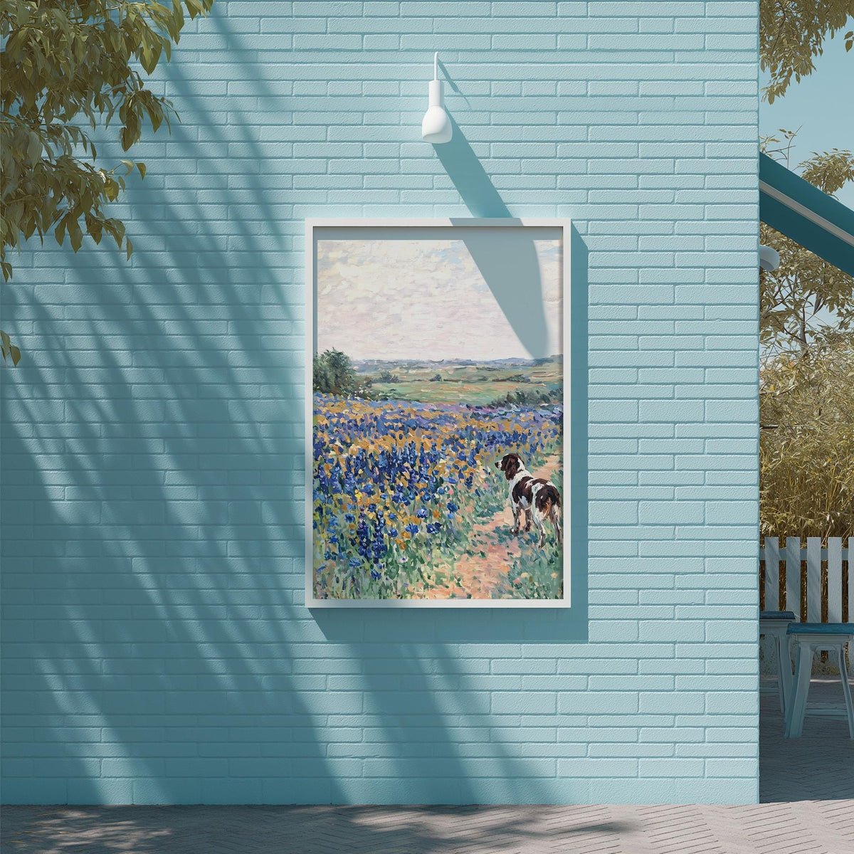 a blue brick wall with a framed painting of a dog in a field of flowers hanging on it.