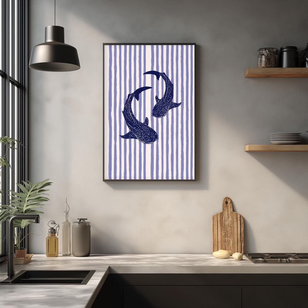 a kitchen counter with a framed picture of two sharks, a wooden cutting board, and various kitchen items such as a bottle, a can, and a bowl.
