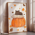 A framed illustration of a cat resting on a pillow, with a pumpkin and autumn leaves in the background.
