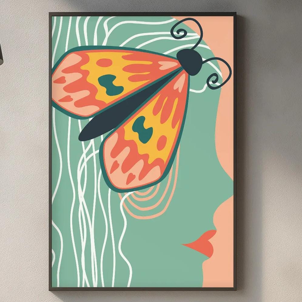 a kitchen counter with a framed artwork of a colorful butterfly on the wall above it. The counter also has various kitchen items such as a cutting board, a soap dispenser, and a bottle.