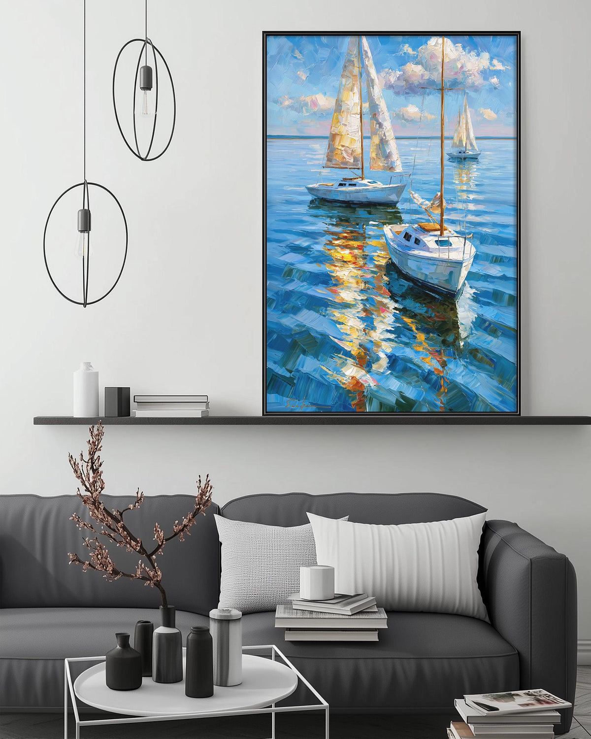 a large painting of sailboats on the water, hanging on a wall above a gray couch with a coffee table in front of it.