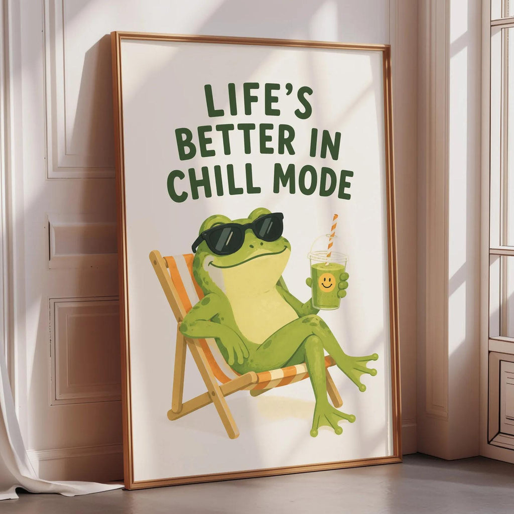 A framed poster with a cartoon frog sitting in a chair, wearing sunglasses and holding a drink, with the text "Life's better in chill mode" written above the image.