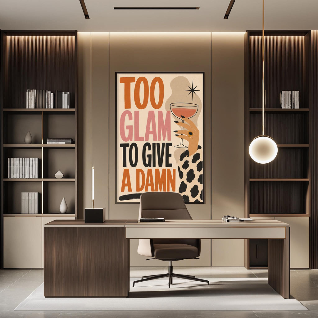 a modern office space with a large framed poster on the wall that reads "Too glam to give a Damn". The office has a wooden desk, a chair, and a bookshelf filled with books. The overall design and decor of the space create a professional and stylish atmosphere.