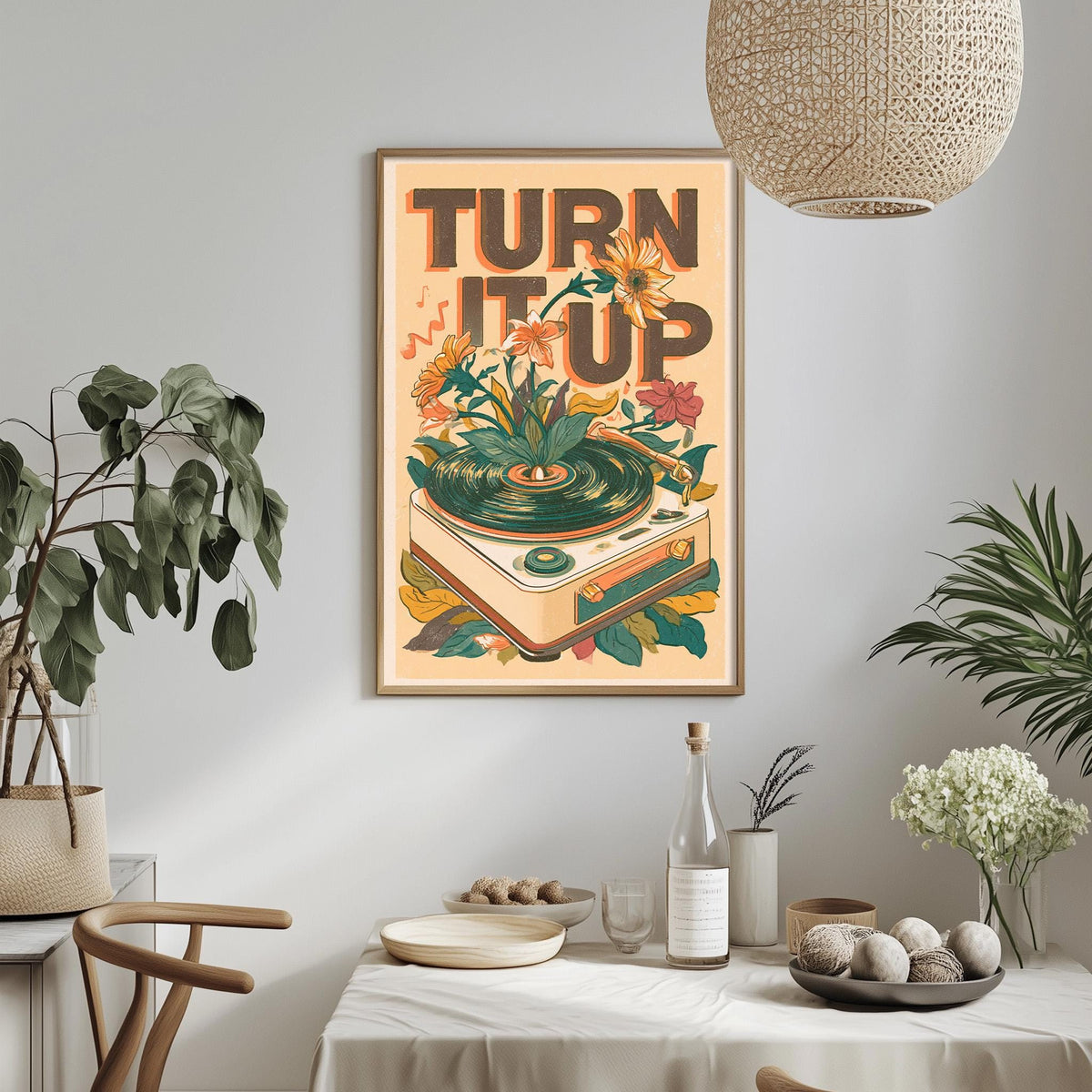 a framed poster with a vibrant design of a record player surrounded by flowers and leaves, hanging on a wall above a dining table with various decorative items and plants.