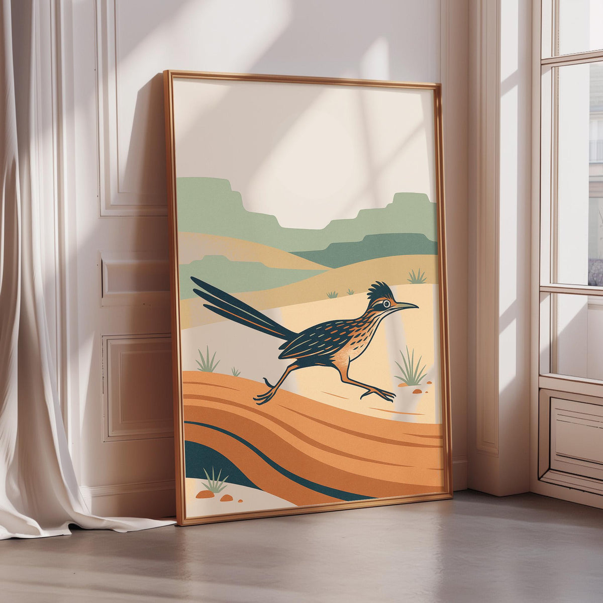 a large, framed poster depicting a bird in mid-flight against a desert landscape with mountains in the background.