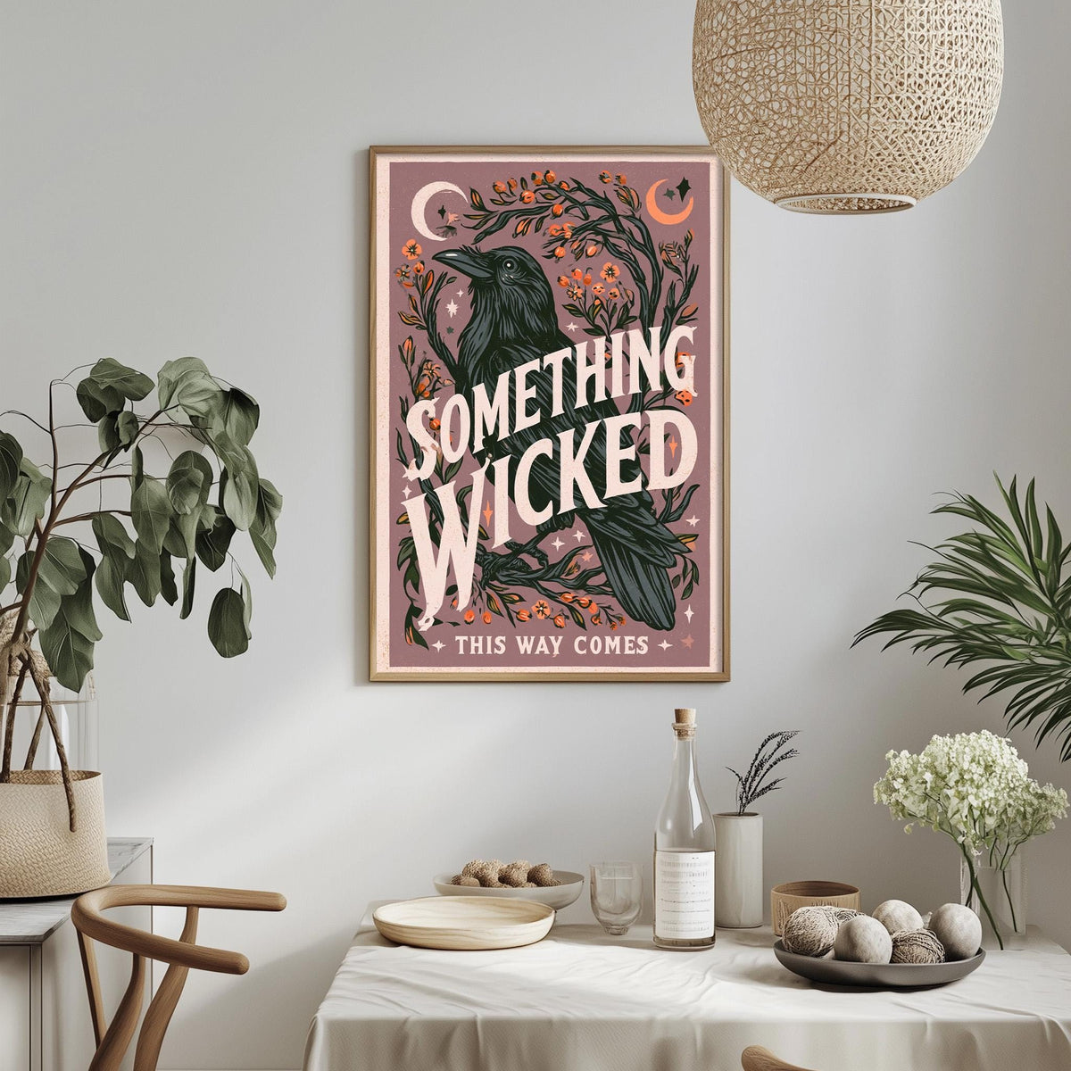 a framed poster with a whimsical illustration of a bird surrounded by plants and flowers, hanging on a wall above a dining table with various items on it.