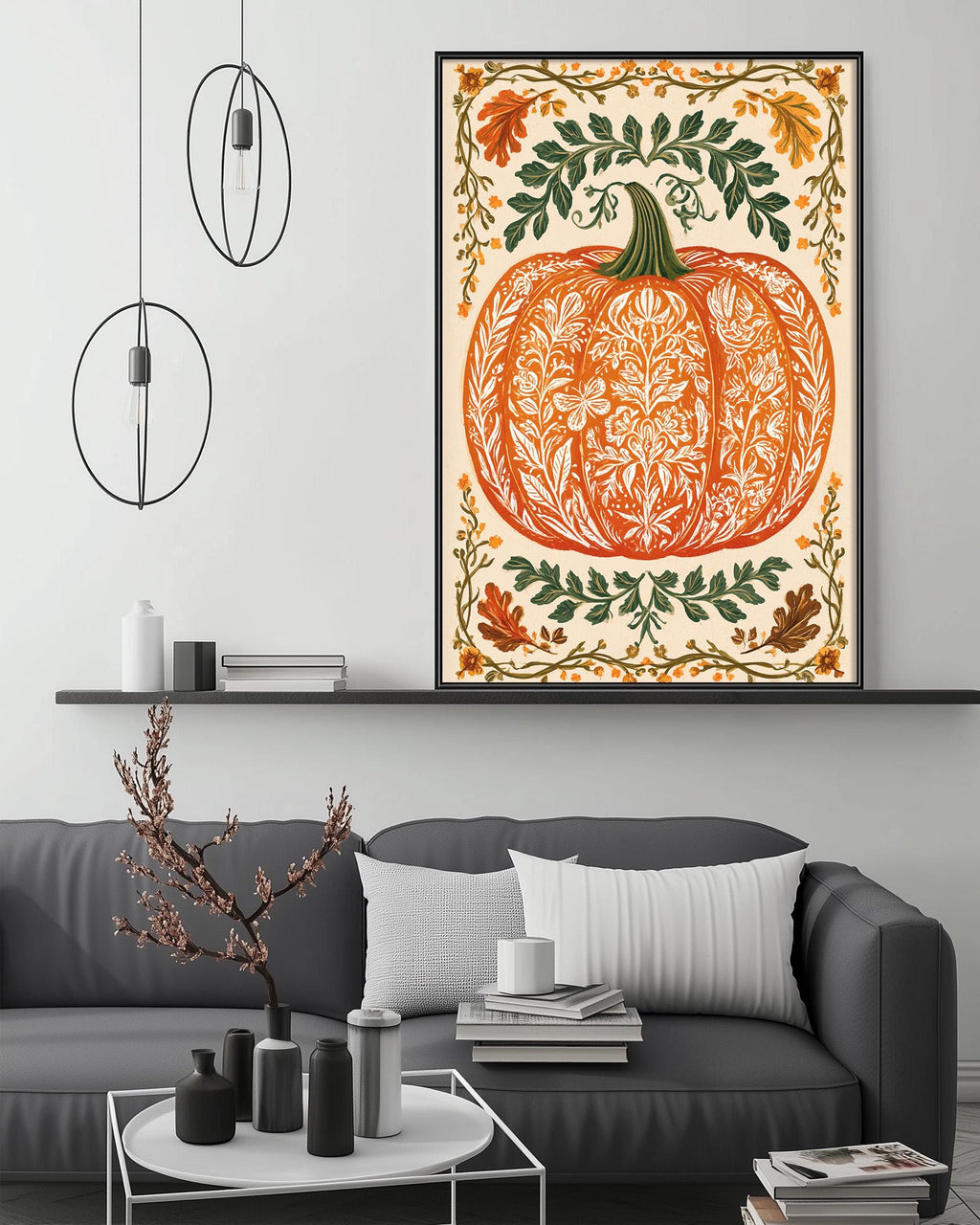 a large, ornate pumpkin-themed artwork hanging on a wall above a gray couch in a living room setting.