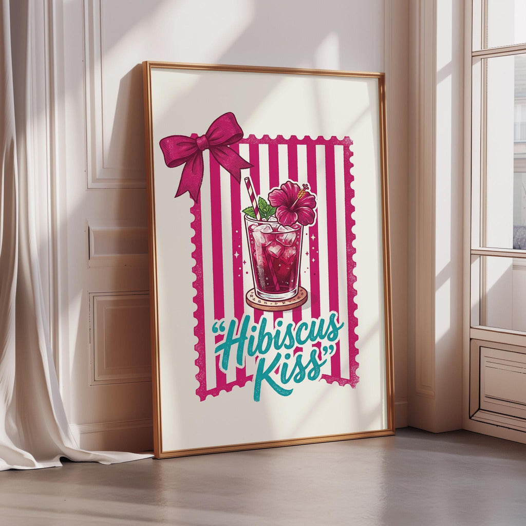 A framed illustration of a glass of hibiscus-infused drink with a bow, accompanied by the text "Hibiscus Kiss" in a stylized font.