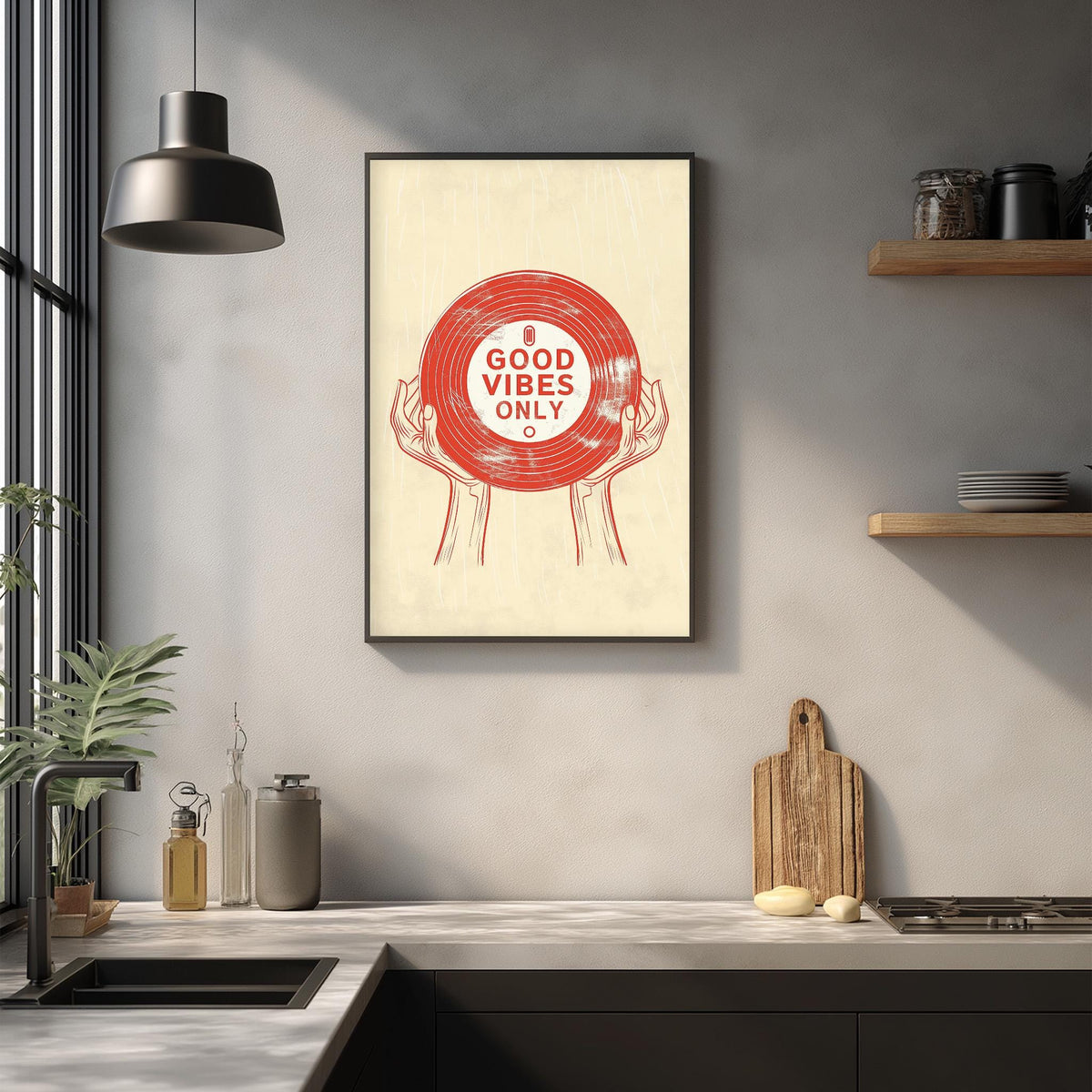 a framed poster with the text "GOOD VIBES ONLY" displayed on a wall above a kitchen counter with various kitchen items such as a cutting board, a knife, and a bottle.
