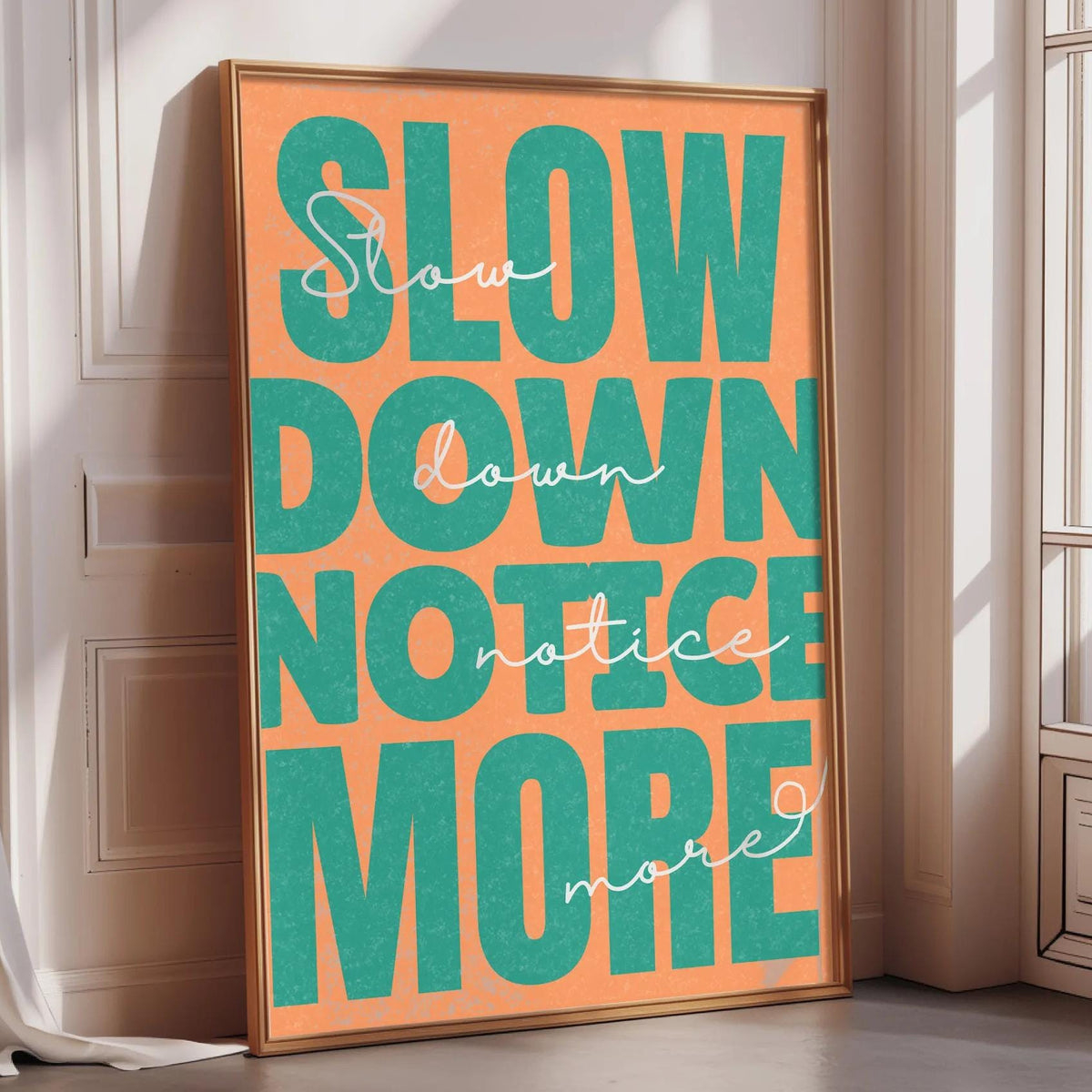 a large, colorful poster with the text "Slow down, notice more" displayed prominently in the center.