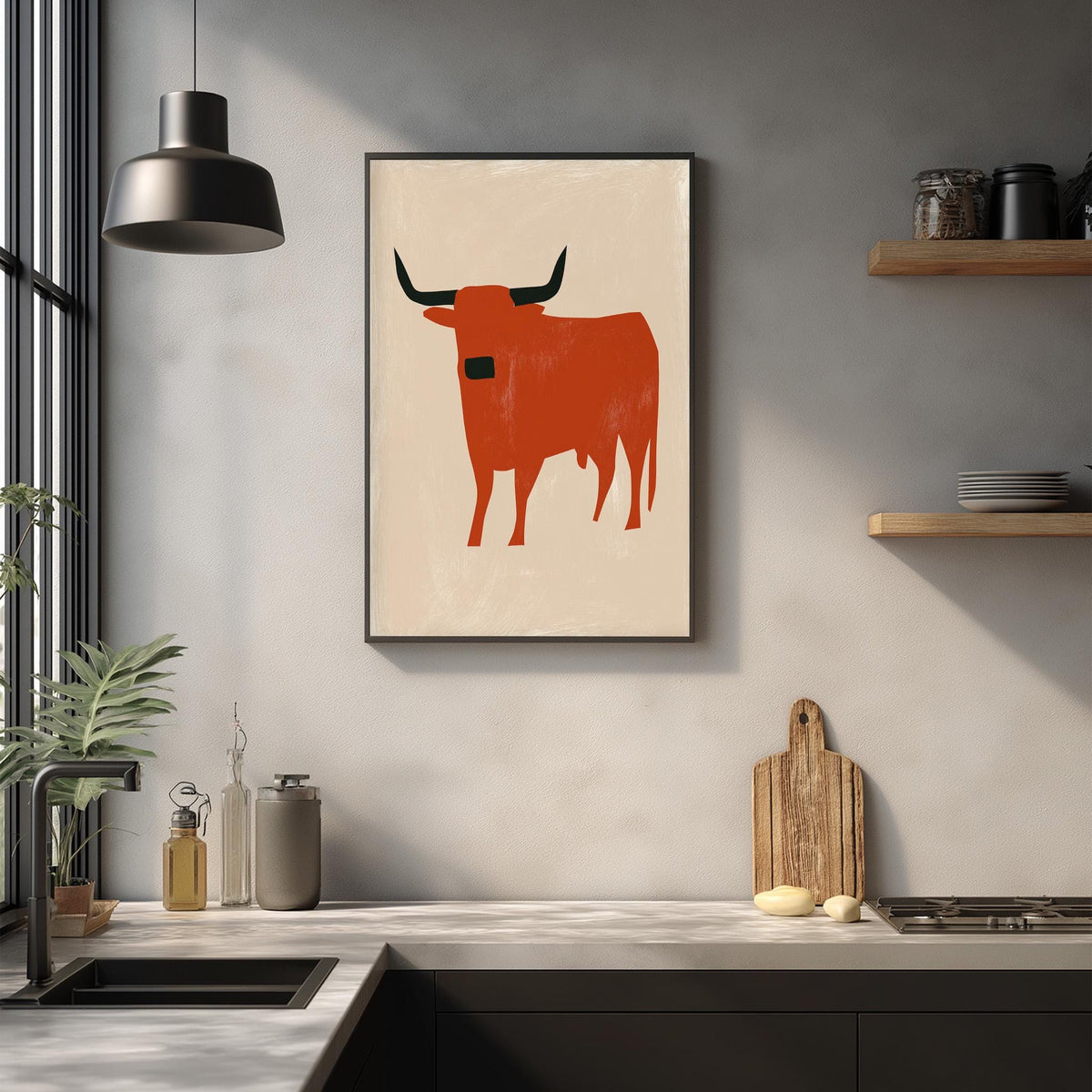 a kitchen counter with a framed picture of a bull on the wall above it.