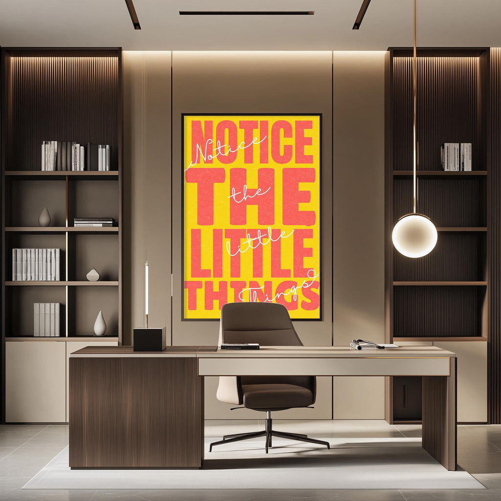 a modern office space with a large, bold, yellow and pink poster on the wall that reads "NOTICE the LITTLE THINGS". The office has a wooden desk and chair, and there are bookshelves on either side of the desk. The overall design and decor of the space create a professional and stylish atmosphere.
