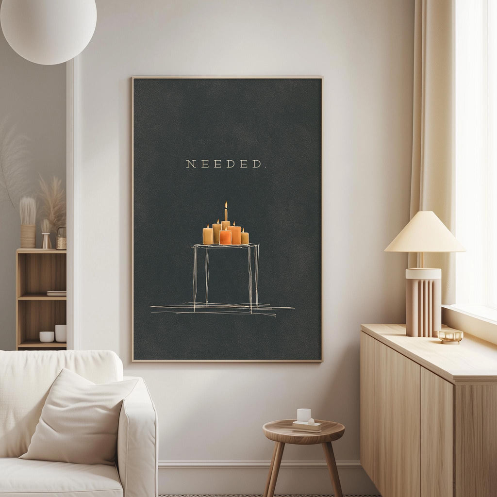 a living room with a large black framed poster hanging on the wall, depicting a table with a candle display. The poster has the word "NEEDED" written on it.