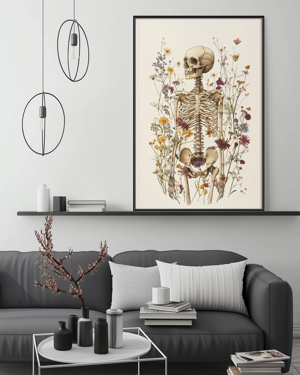 a living room with a gray sofa, a coffee table, and a large framed print of a skeleton surrounded by flowers on the wall.