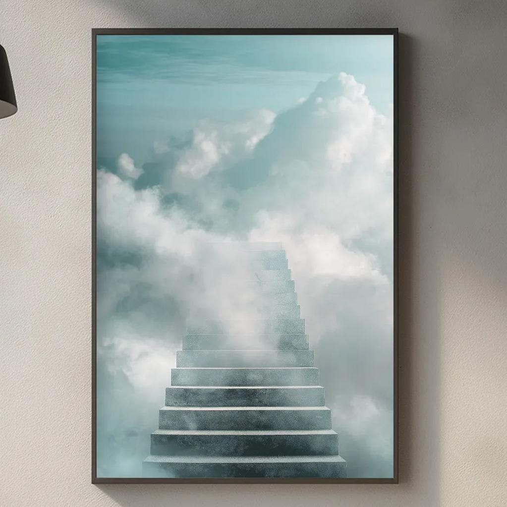 a kitchen counter with a framed picture of a staircase leading up to a sky filled with clouds, creating a dreamlike atmosphere.