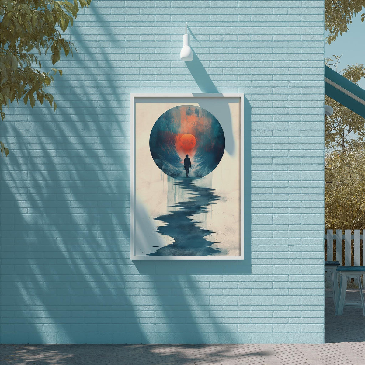 a blue brick wall with a framed painting of a person standing in front of a large circular design, which appears to be a representation of a sunrise or sunset.