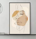 a modern living room with a gray sofa, a coffee table, and a large abstract portrait of a woman's face hanging on the wall above the sofa.