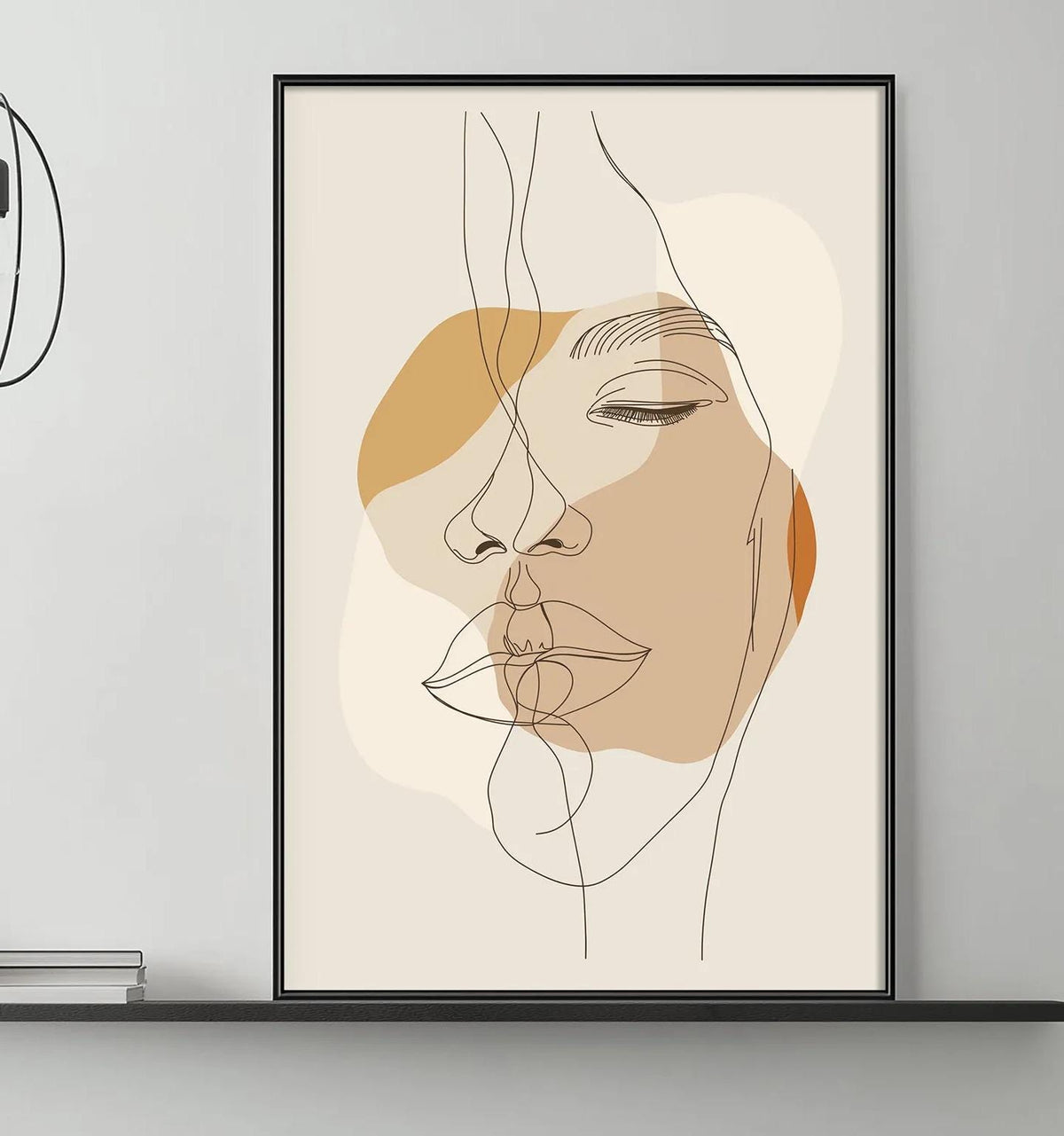 a modern living room with a gray sofa, a coffee table, and a large abstract portrait of a woman's face hanging on the wall above the sofa.