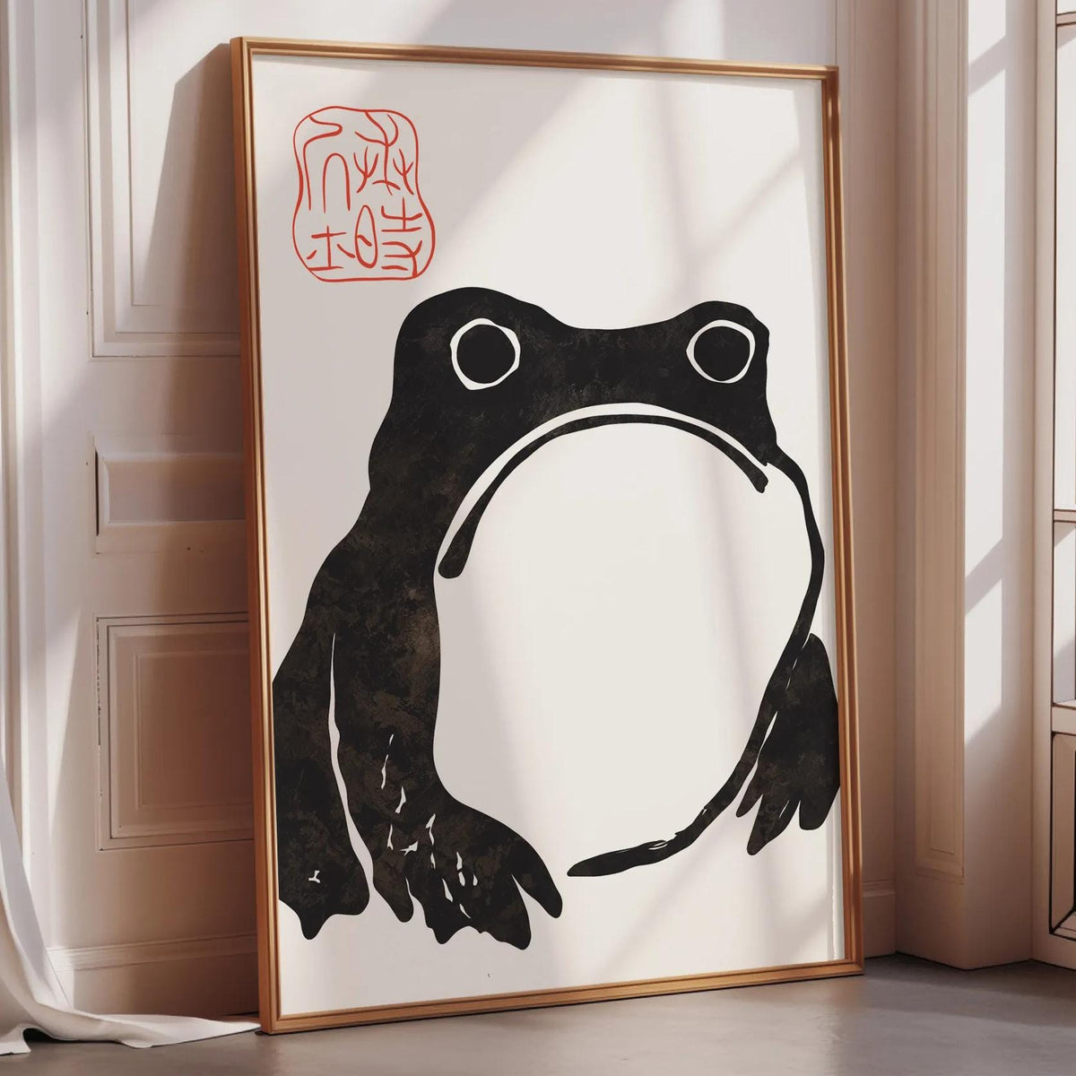 a large framed artwork depicting a black frog with a red stamp on the top left corner.