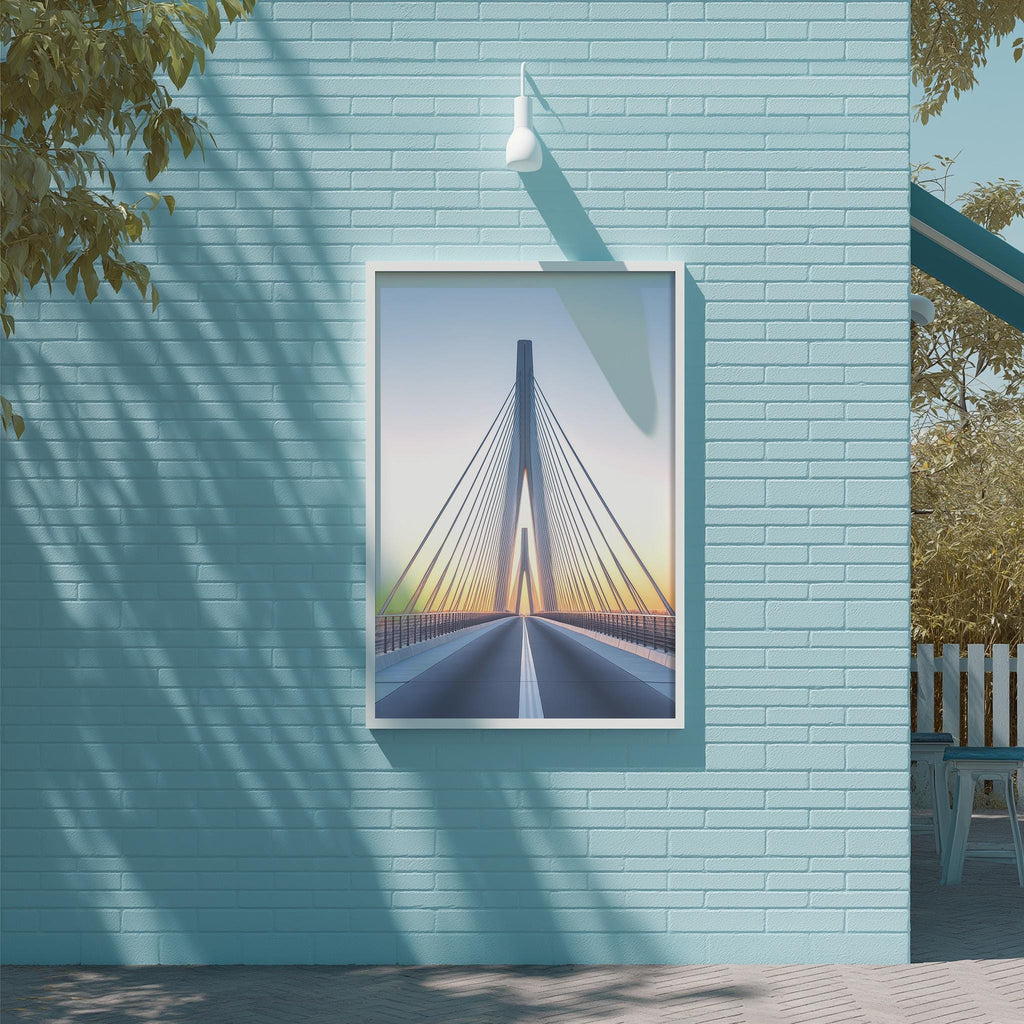 a blue brick wall with a framed picture of a suspension bridge hanging on it.