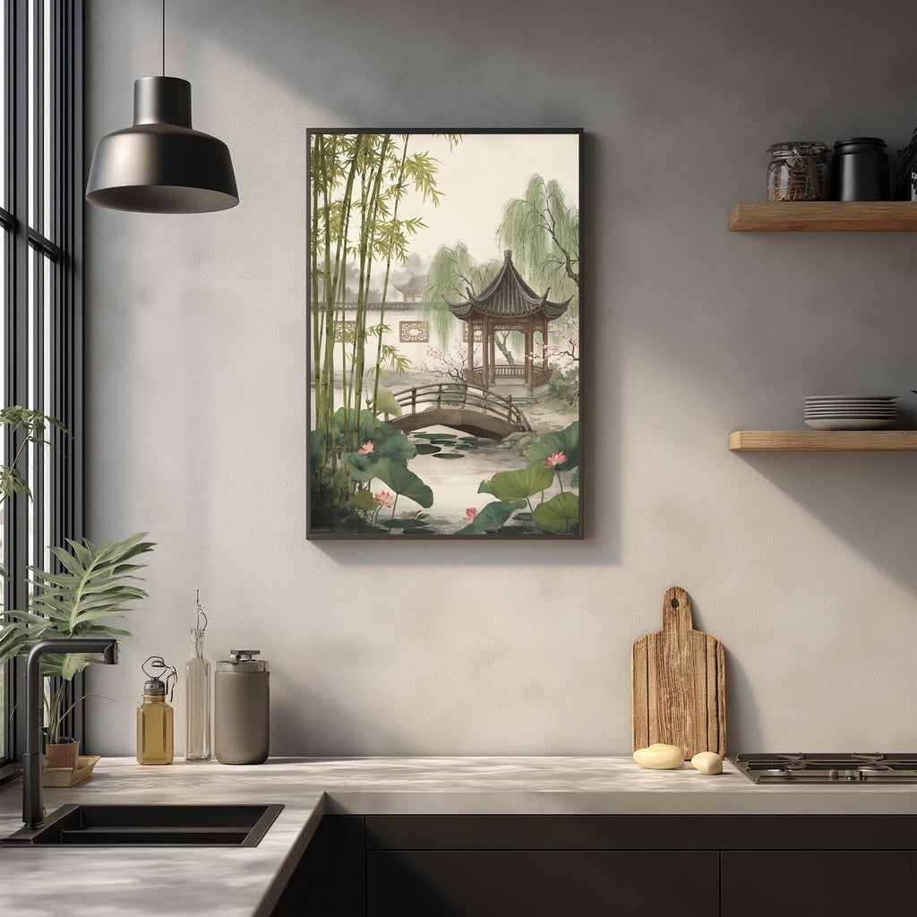 a serene Asian-inspired garden scene with a pagoda, bamboo, and water features, all set against a light gray wall. The garden is framed by a black border and is hung on the wall above a kitchen counter with various kitchen items, such as a cutting board, bowls, and a vase.