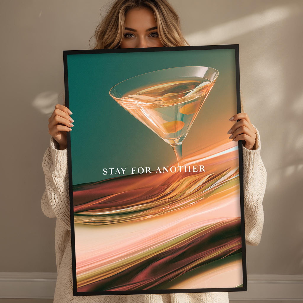 A woman holding a framed poster with a colorful abstract design featuring a martini glass.