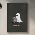 a kitchen counter with various items, including a plant, a cutting board, and a sink. Above the counter, there is a framed illustration of a ghost holding a book and the text "How to be a scary ghost" written on it.