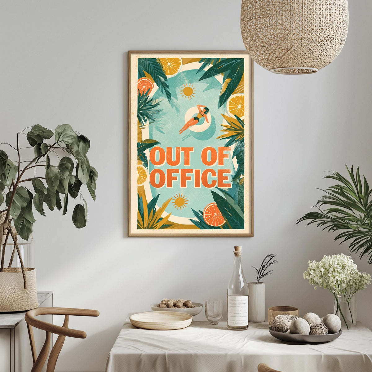 a framed poster with a tropical design hanging on a wall, surrounded by various decorative elements such as potted plants, vases, and a dining table with a bowl of fruit.