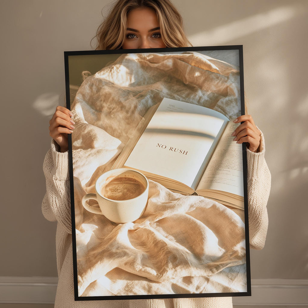A woman holding a framed picture of a book and a cup of coffee, with the words "NO RUSH" visible on the book cover.