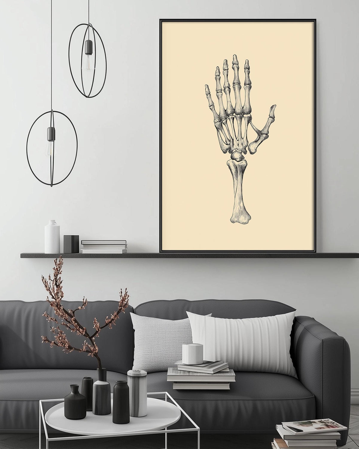 a living room with a gray sofa, a coffee table, and a large framed illustration of a human hand on the wall above the sofa.