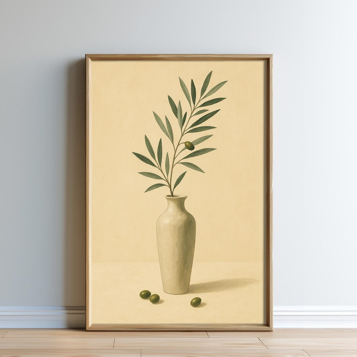 A framed painting depicting a green olive branch with leaves and a vase of olives on a wooden floor against a beige background.