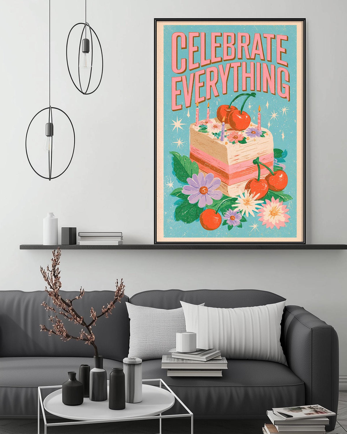 a cozy living room with a gray couch, a coffee table, and a large framed poster on the wall that reads "Celebrate Everything".