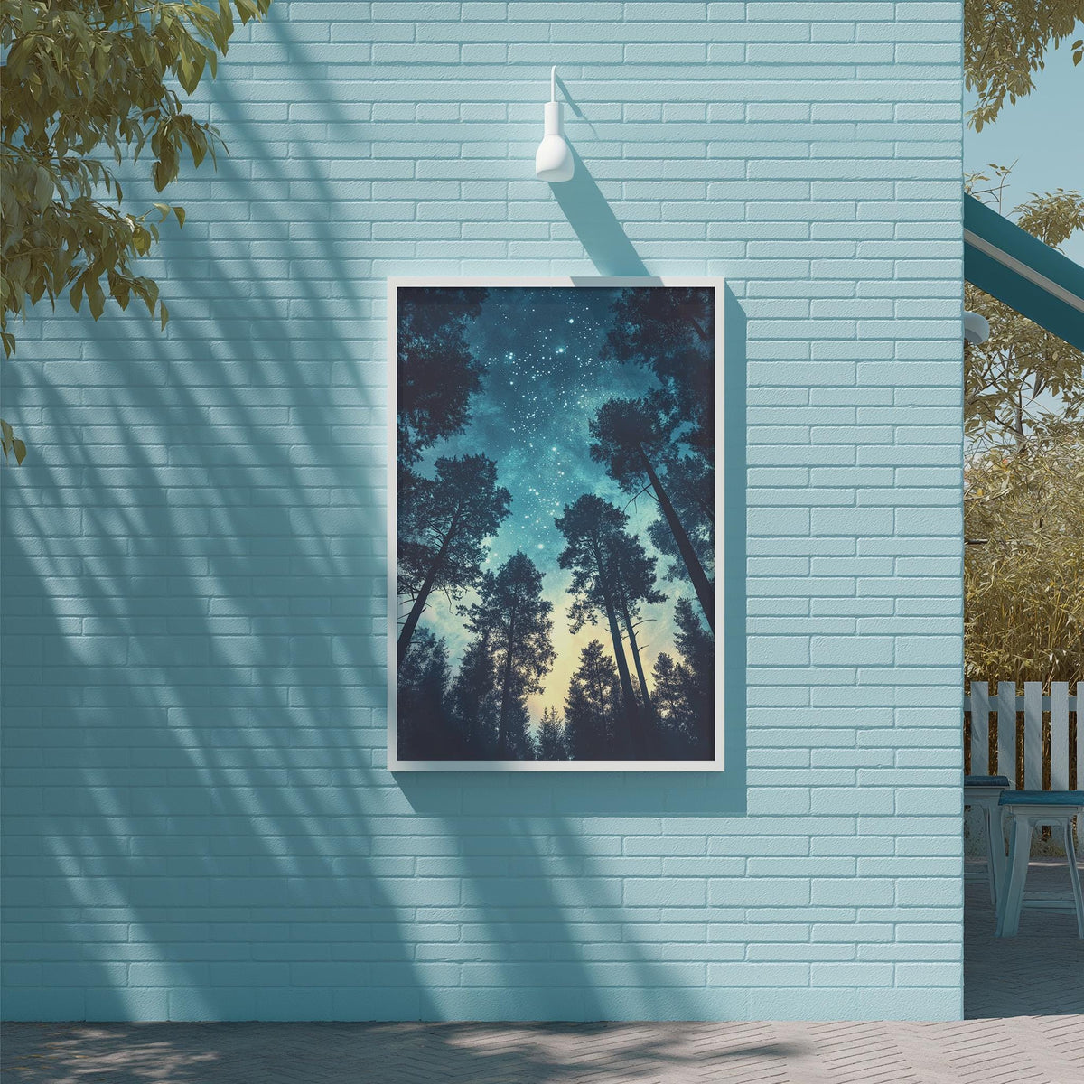 a blue brick wall with a framed picture of a starry night sky hanging on it.