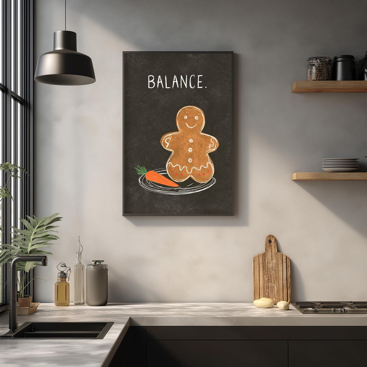 a kitchen counter with various kitchen items, including a gingerbread man figure, a cutting board, and a sink. Above the counter, there is a framed image of a gingerbread man with a carrot on its plate, accompanied by the word "BALANCE."