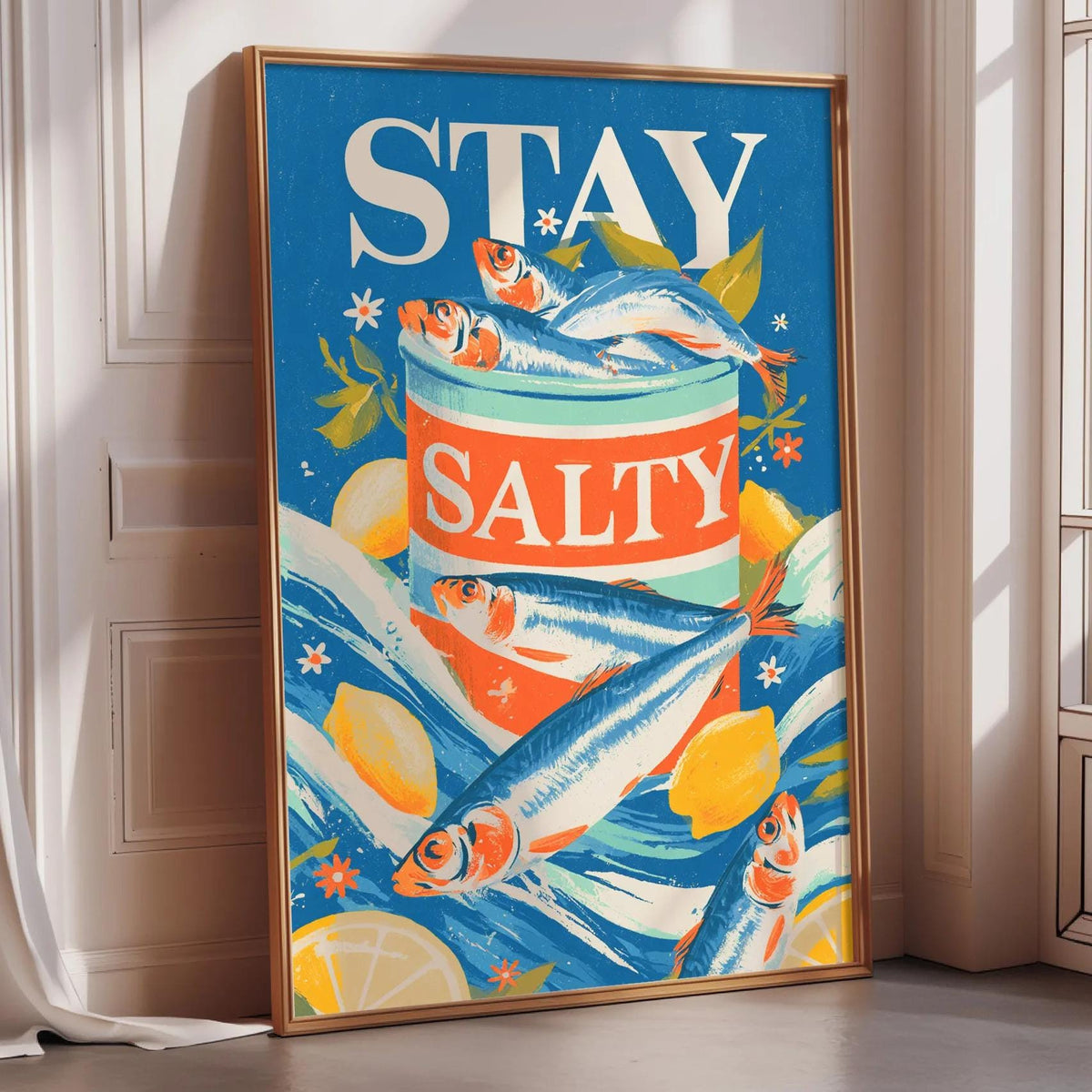 a framed poster with a vibrant design of fish and citrus fruits, along with the text "STAY SALTY".