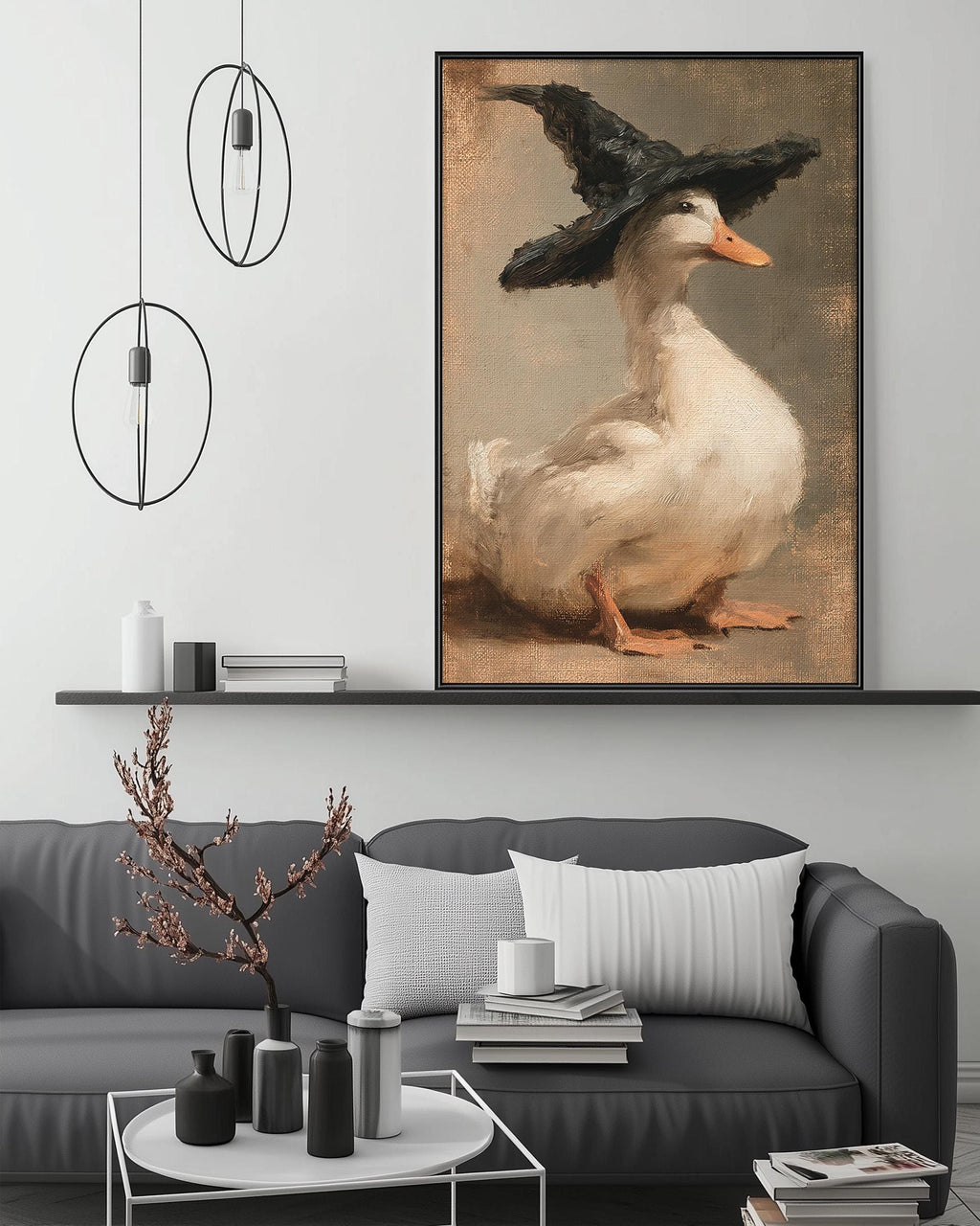 a cozy living room with a gray couch, a coffee table, and a large painting of a duck wearing a black hat. The painting is hanging on the wall above the couch, creating a focal point in the room.