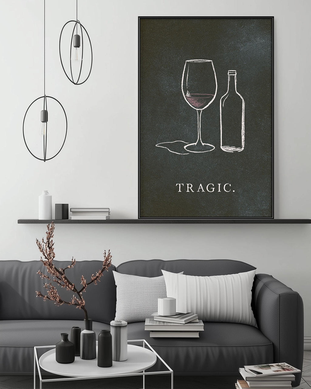 a living room with a gray sofa, a coffee table, and a large framed artwork depicting wine glasses and a bottle on the wall.