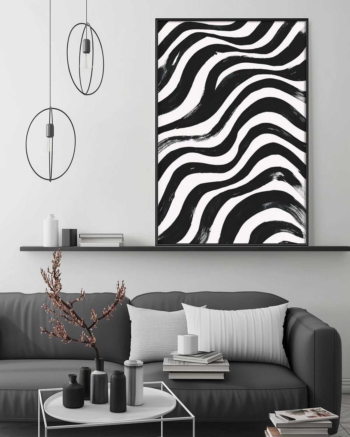 a modern living room with a gray sofa, a coffee table, and a large abstract painting with black and white stripes hanging above the sofa.