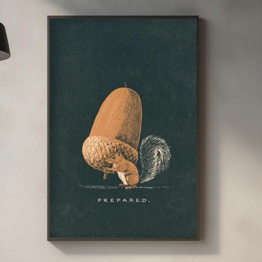 a kitchen counter with various kitchen items, including a cutting board, a bottle, and a plant. Above the counter, there is a framed illustration of an acorn with the word "PREPARED" written below it.