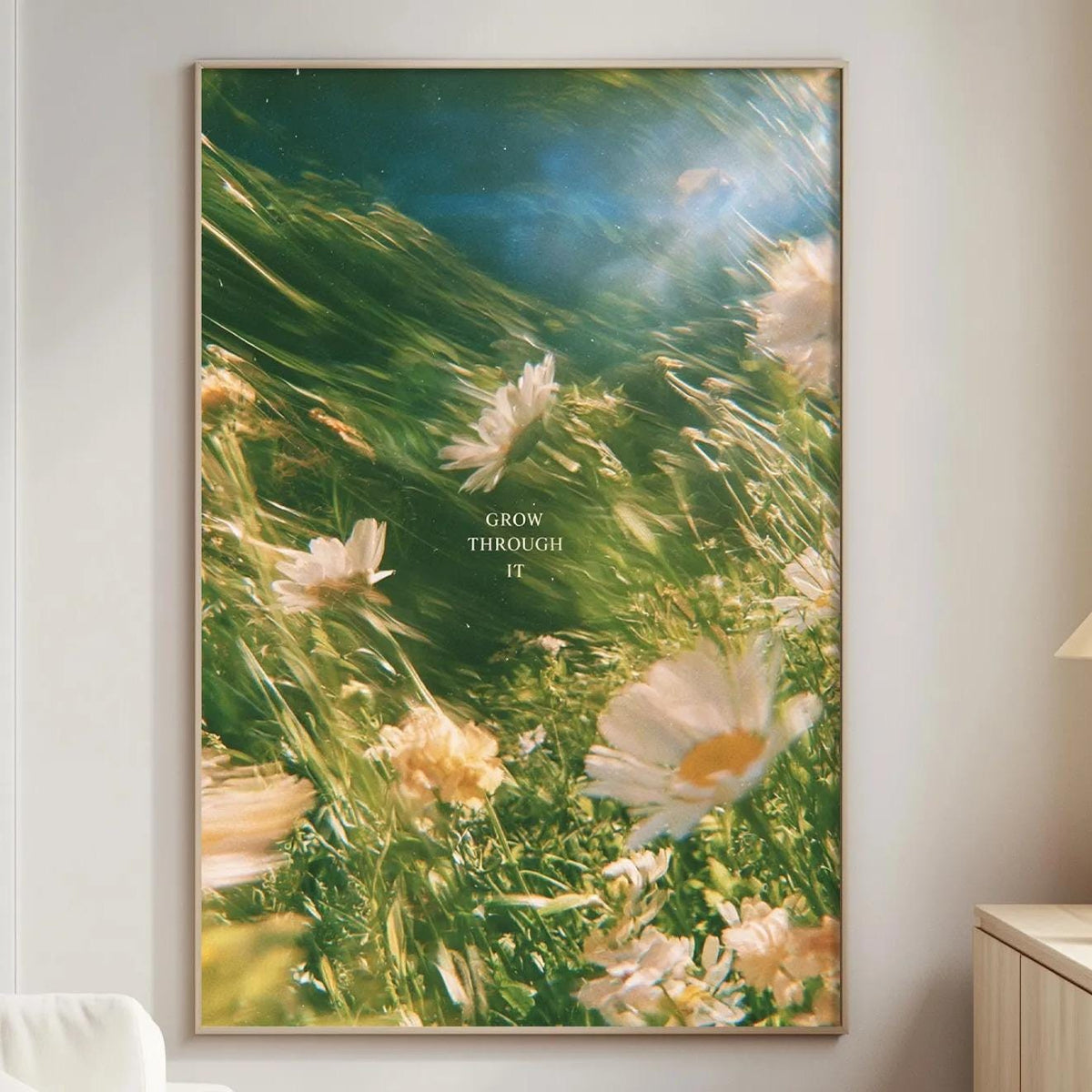 a large framed picture of flowers hanging on a wall in a living room.