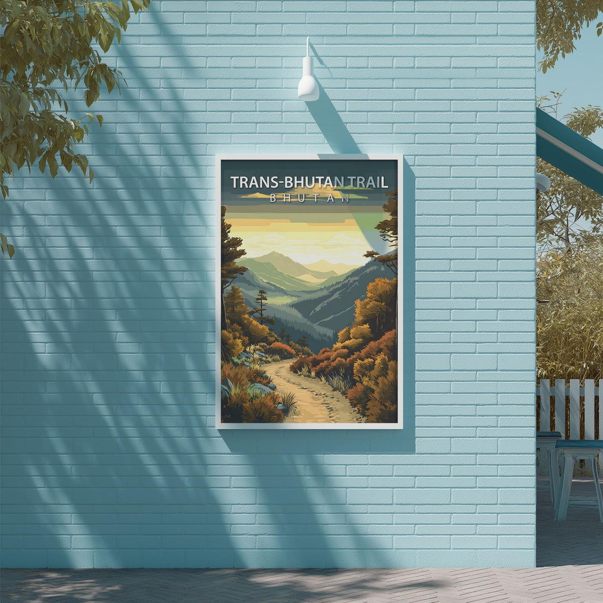 a poster for the Trans Bhutan Trail, which is a mountain trail in Bhutan. The poster is displayed on a blue brick wall, and there is a bench and a tree visible in the background.