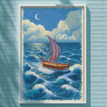 a painting of a sailboat on the ocean, hanging on a blue wall.