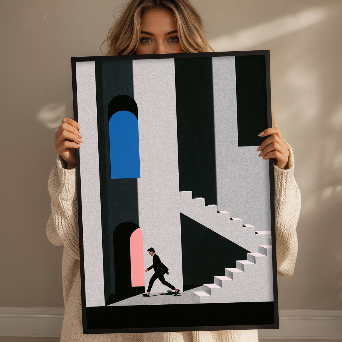 A woman holding a framed poster with a minimalist design featuring a person walking down a staircase.