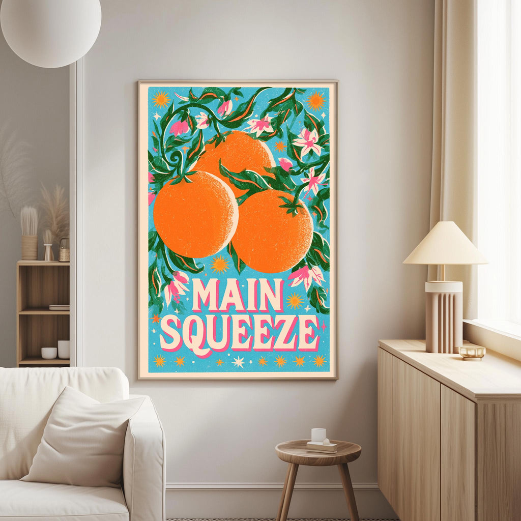 a vibrant poster of oranges hanging on a wall in a living room.