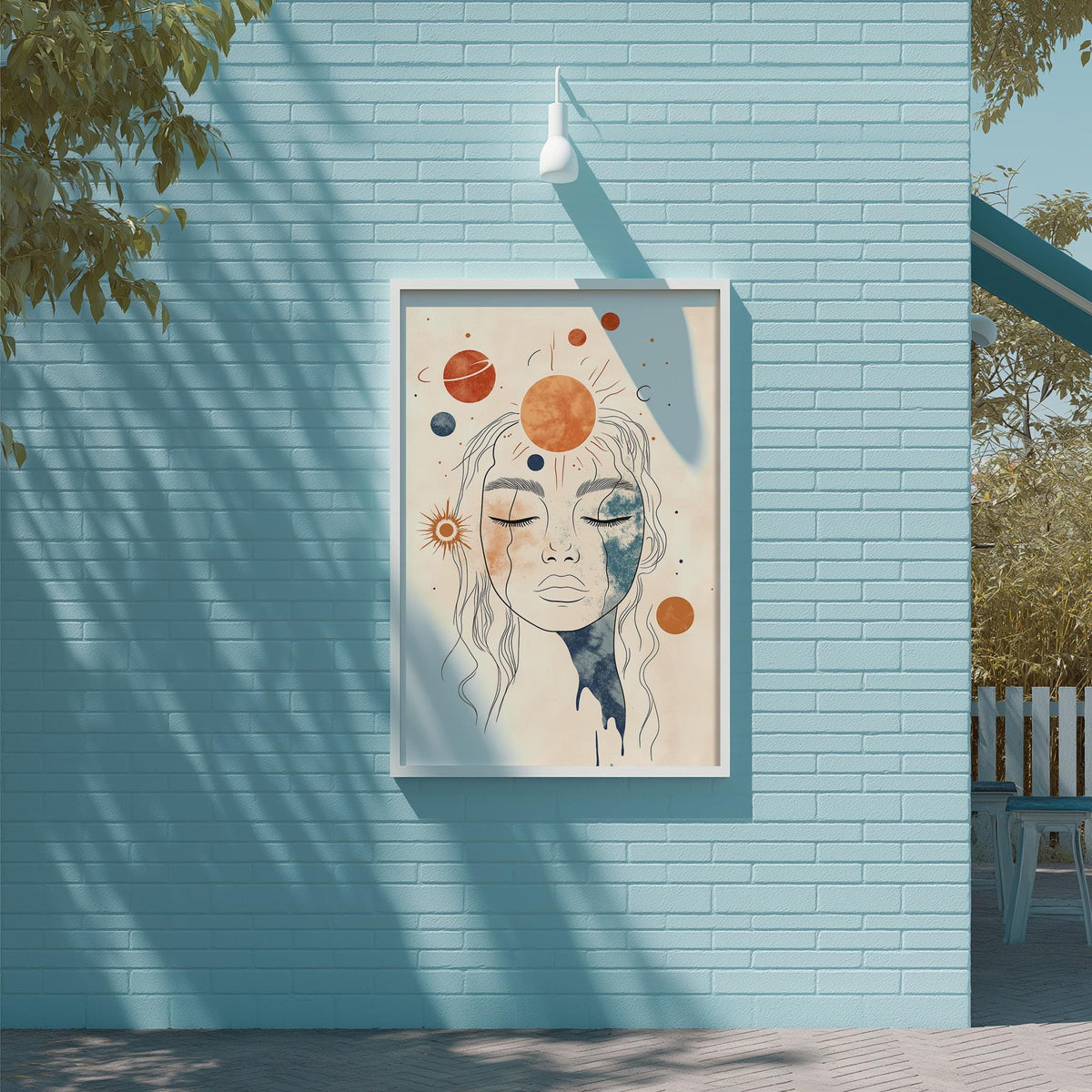 a framed artwork of a woman's face with a cosmic background, hanging on a blue brick wall.