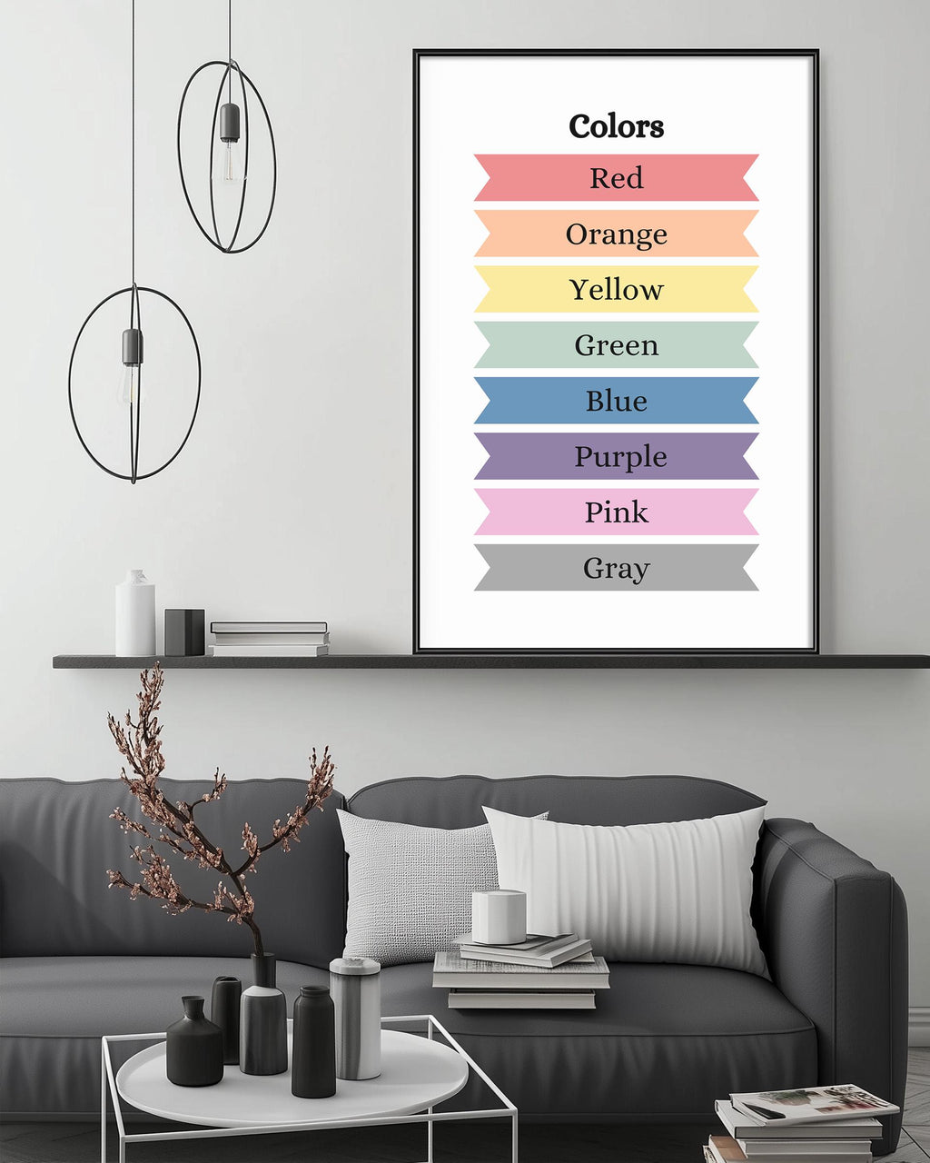 a modern living room with a gray sofa, a coffee table, and a framed poster of color names above it.