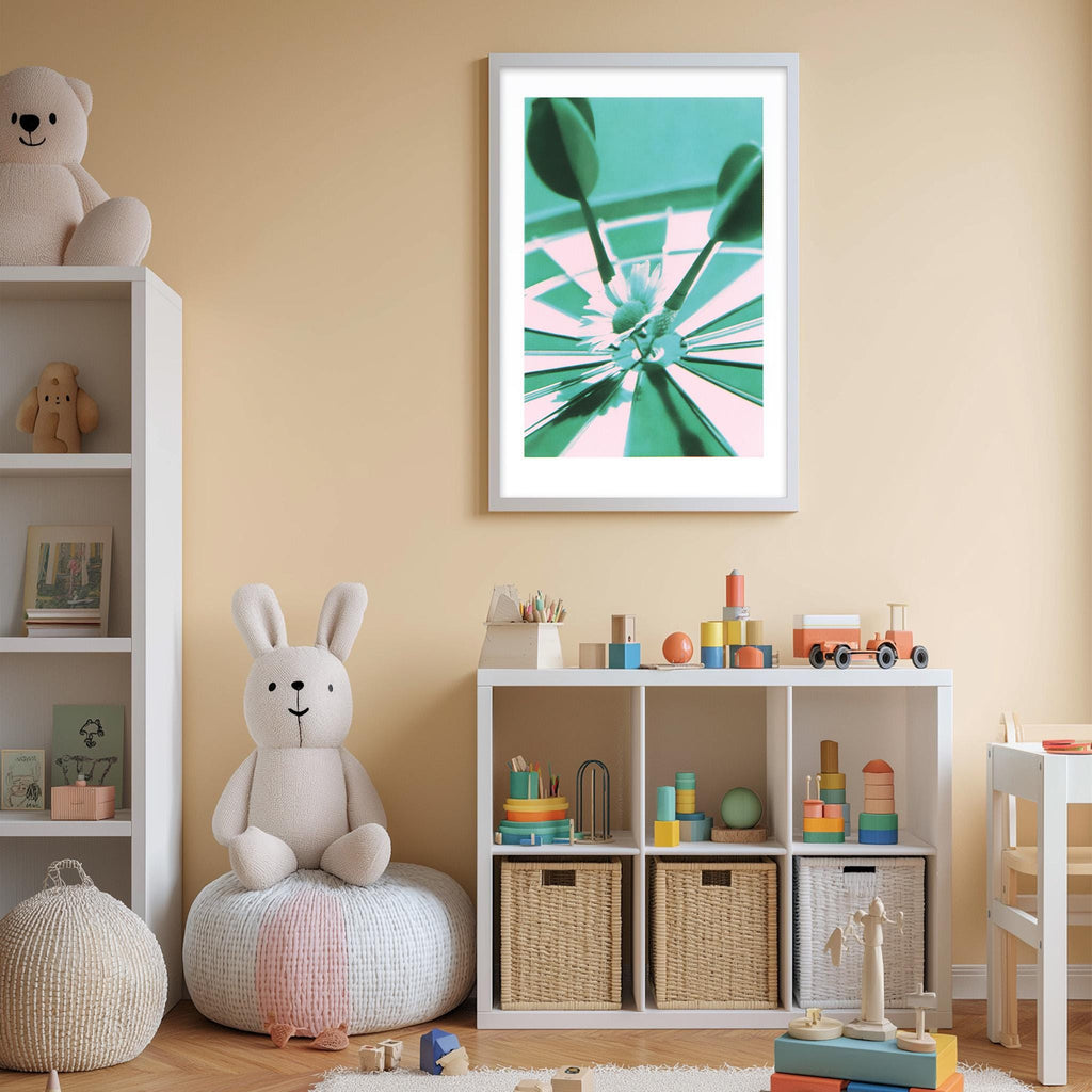 A cozy and colorful children's bedroom with a white bookshelf, a plush rabbit, and a toy train set. The walls are painted a light peach color, and there is a framed abstract art piece hanging on the wall.