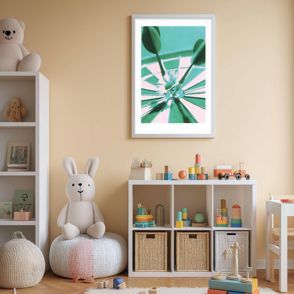 A cozy and colorful children's bedroom with a white bookshelf, a plush rabbit, and a toy train set. The walls are painted a light peach color, and there is a framed abstract art piece hanging on the wall.