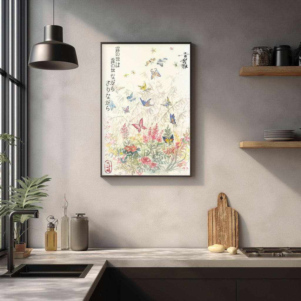 a kitchen counter with a framed print of a floral design hanging above it, along with various kitchen items such as a cutting board, a soap dispenser, and a plant.