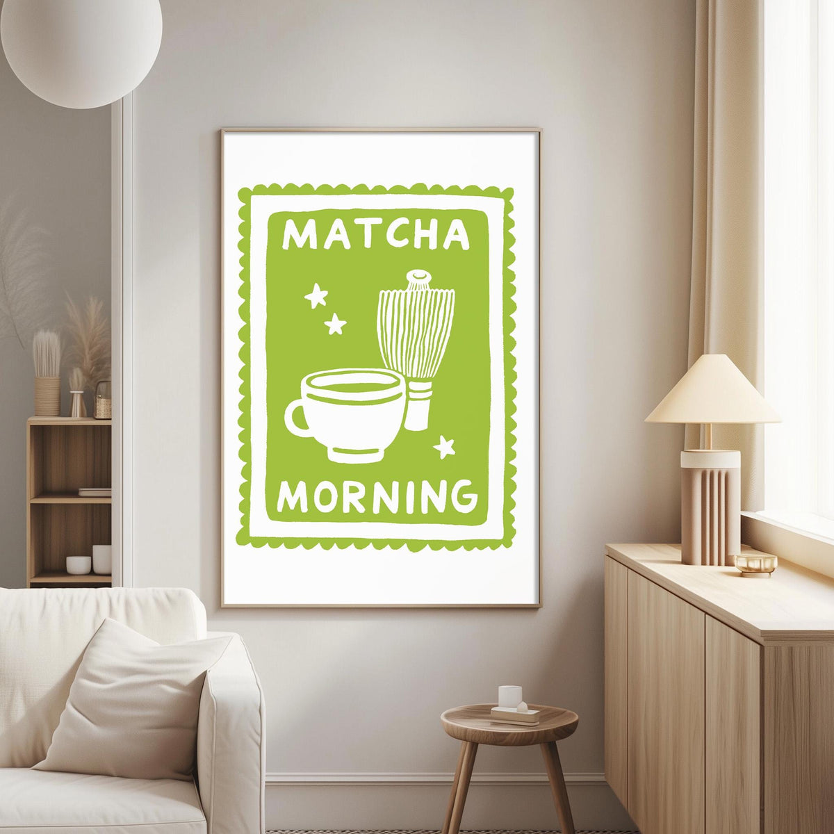 a living room with a framed poster on the wall that reads "MATCHA MORNING" and includes a cup and a whisk.